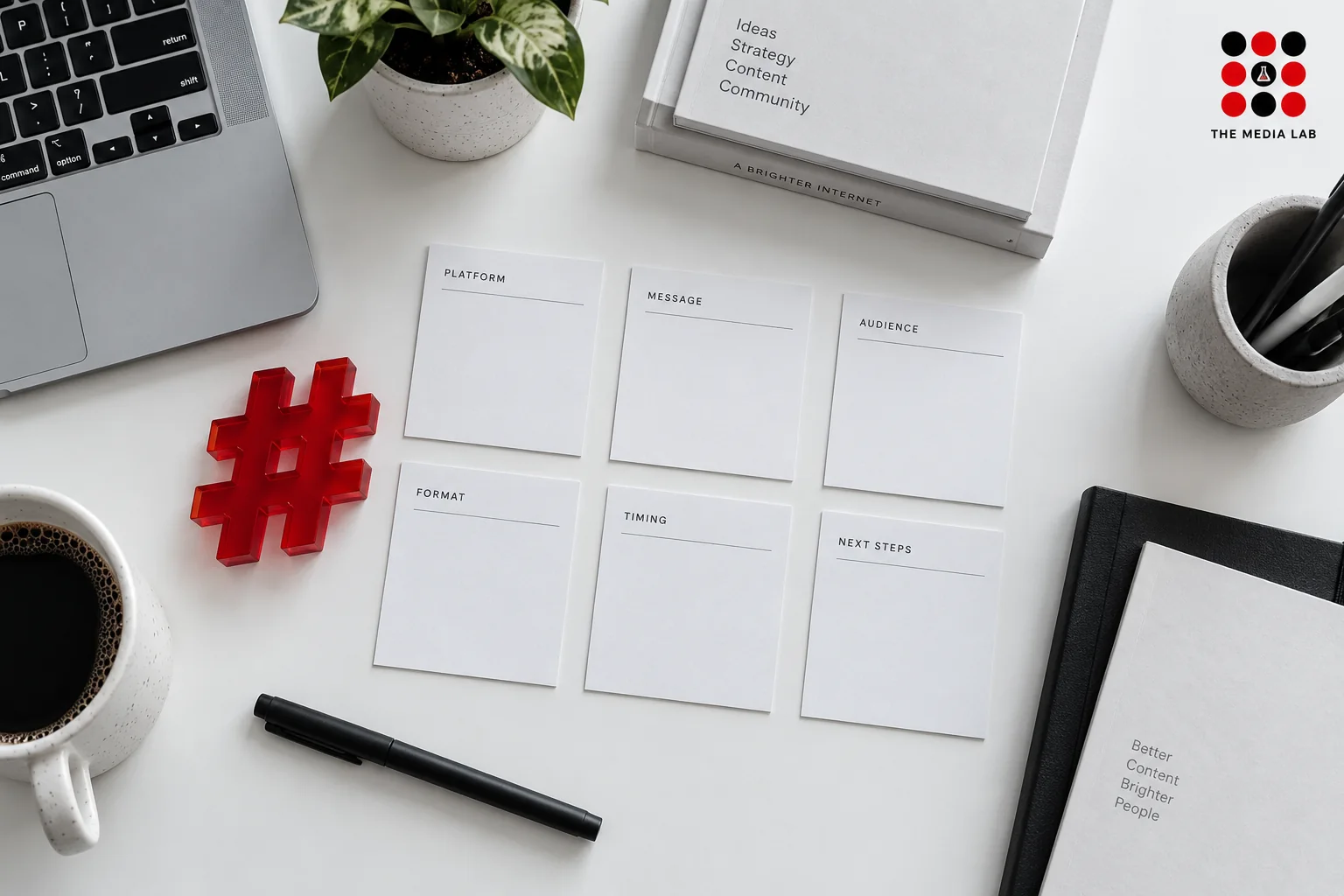 Red hashtag object and content planning cards on a white desk — Dubai hashtag illustration for The Media Lab.