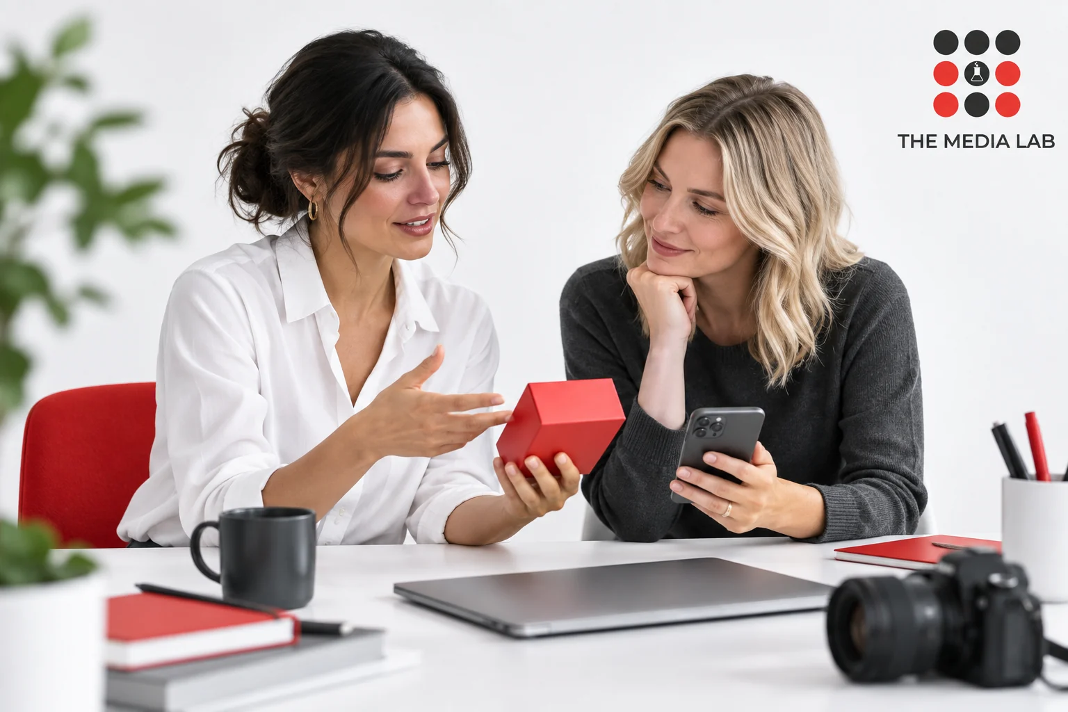 Two professionals discussing product content for The Media Lab’s guide to influencer brand collaborations in the UAE.