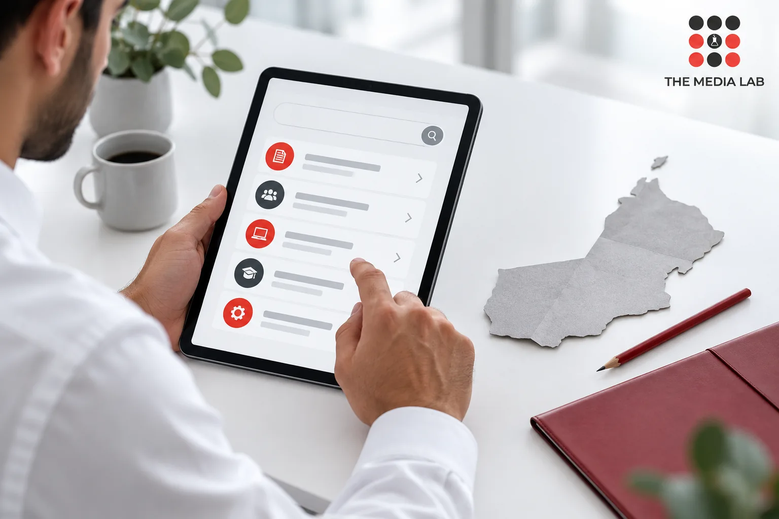 Professional reviewing an online directory on a tablet, illustrated for The Media Lab’s Oman website guide