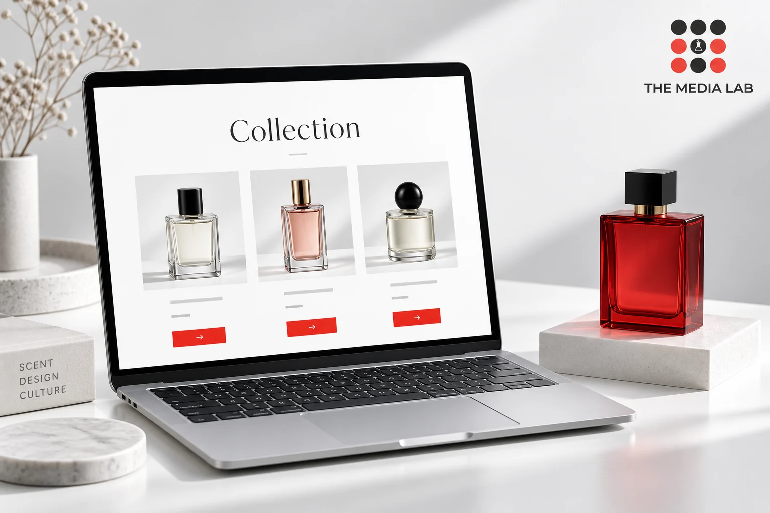 Concept laptop display and red perfume bottle illustrating luxury website design by The Media Lab.