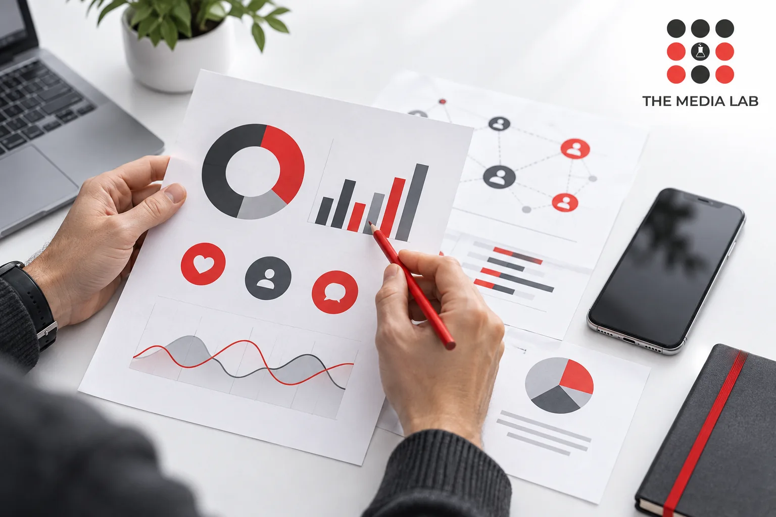 Hands reviewing abstract social charts with a red pencil — editorial illustration for The Media Lab.