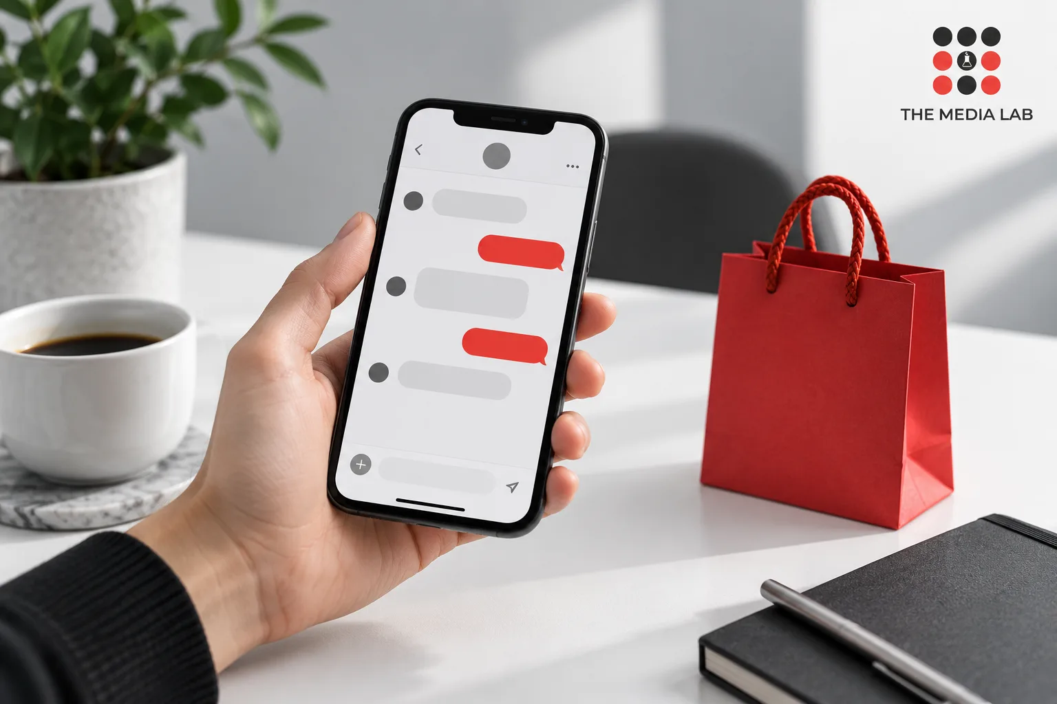 Hand holding a phone beside a red shopping bag — editorial illustration for The Media Lab.