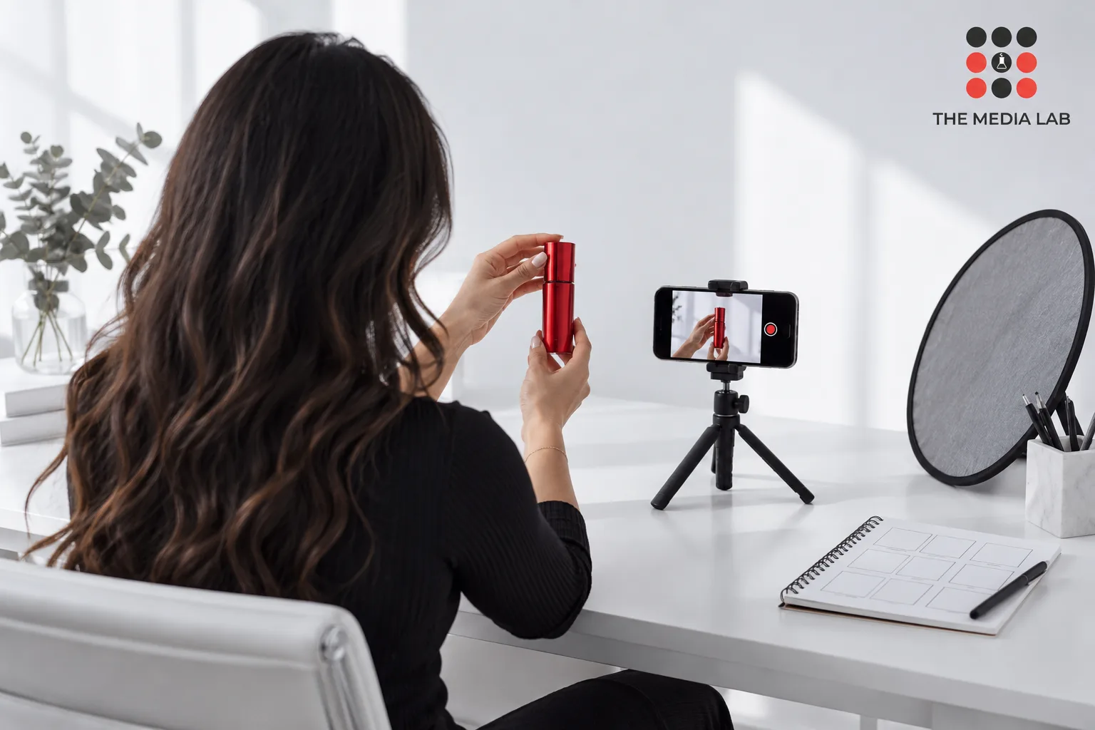 Creator filming a red cosmetic product, illustrating Instagram campaign production for The Media Lab.