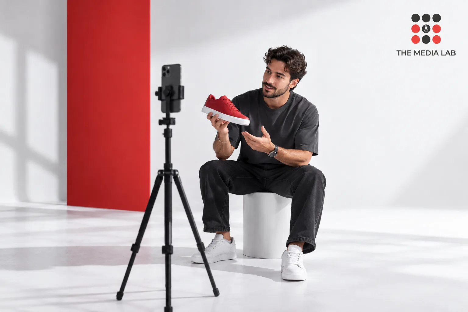 Creator filming a red sneaker demonstration, illustrating influencer content planning for The Media Lab.