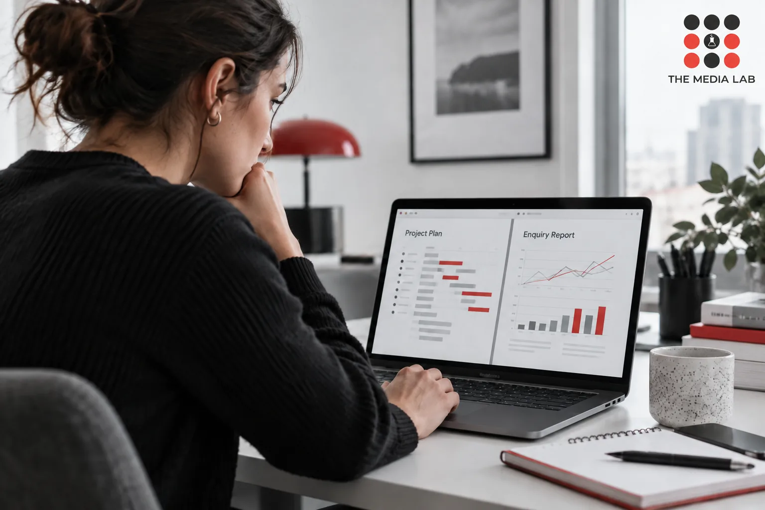 SEO consultant comparing a project plan with an enquiry report on a laptop — The Media Lab