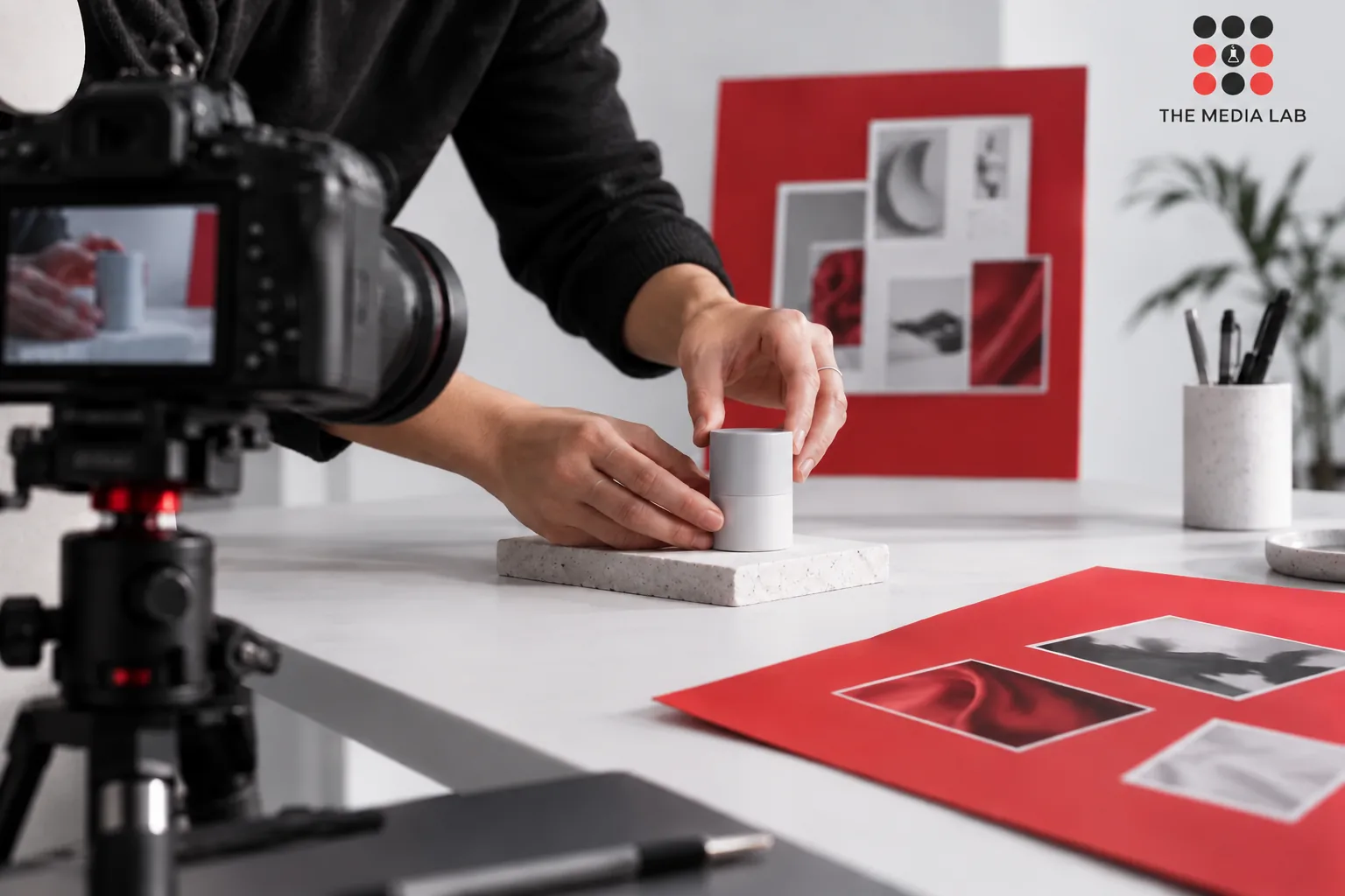 Creator preparing a product shot with a camera and campaign brief — The Media Lab