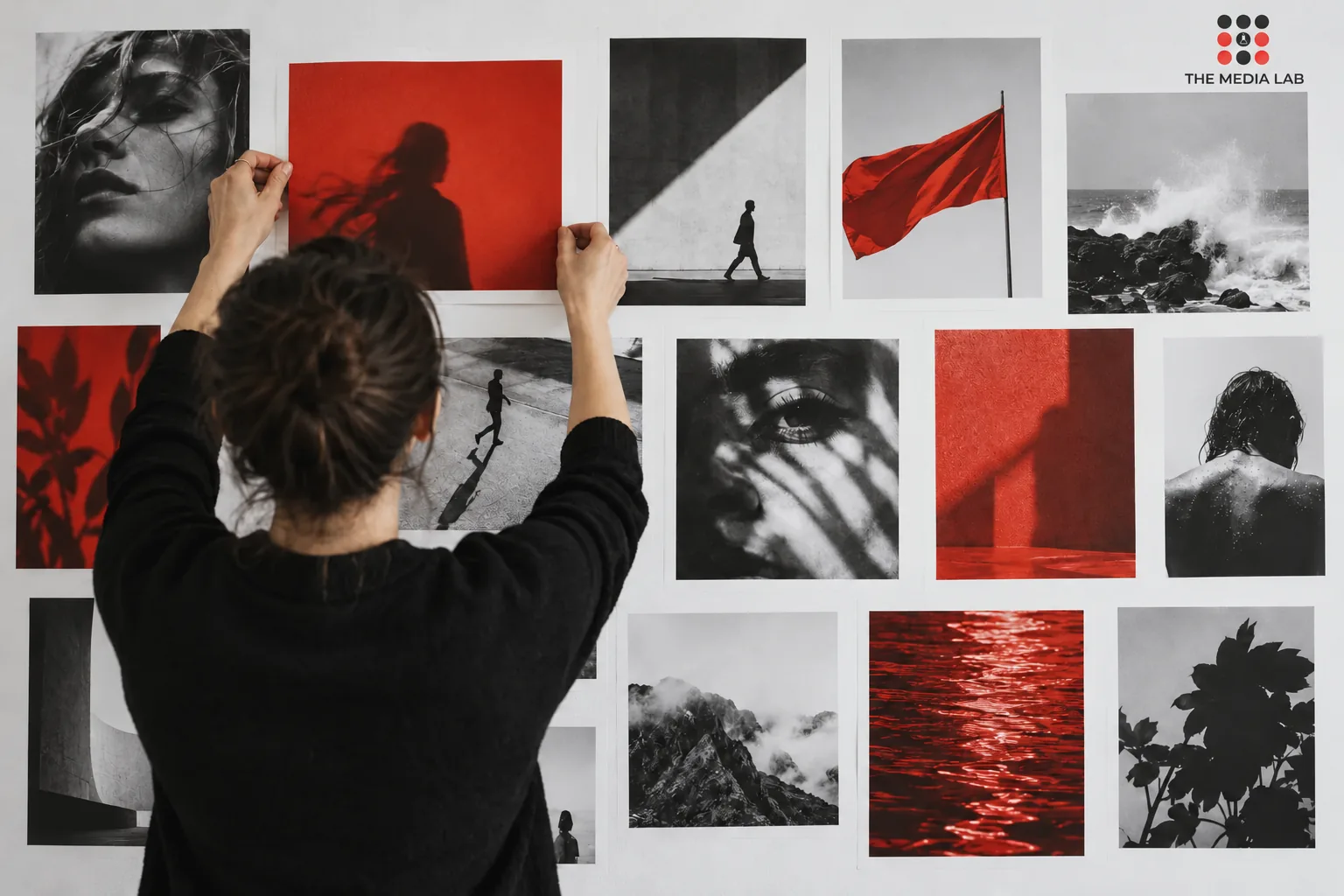 Creative arranging red and monochrome photographs on a wall — The Media Lab