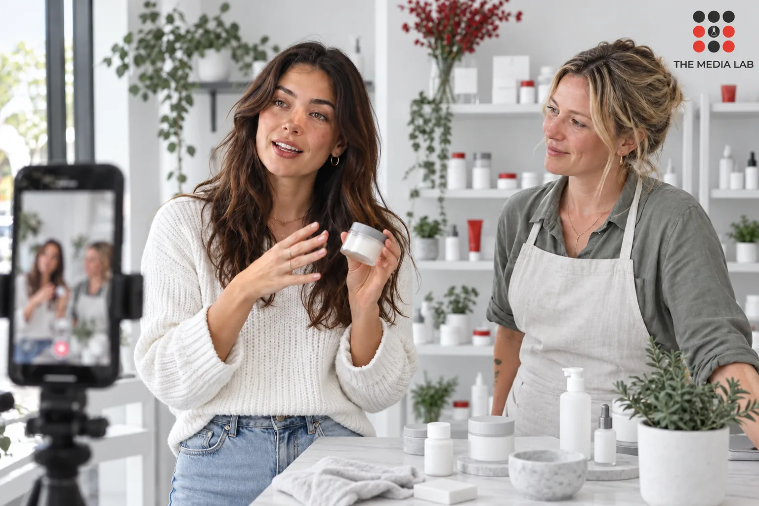 Creator demonstrating a product beside a shop owner, illustrating a brand collaboration for The Media Lab’s influencer marketing guide.